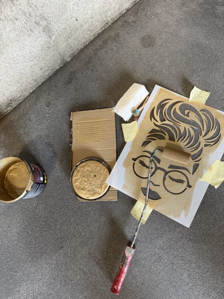 Peeling off a stencil while paint is still wet to prevent smudging