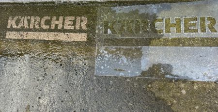 Reverse graffiti stencil used with a pressure washer to create a clean, branded sidewalk design