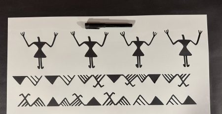 Printed layout of a prehistoric stencil design with marker for scale